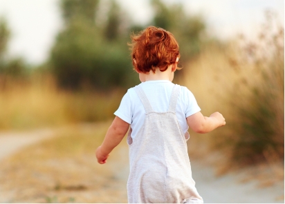 Small child walking along a path