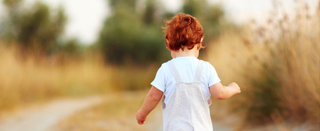 Small child walking along a path